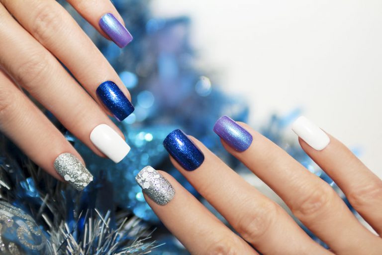 50754346 - christmas blue and silver with white nail polish manicure